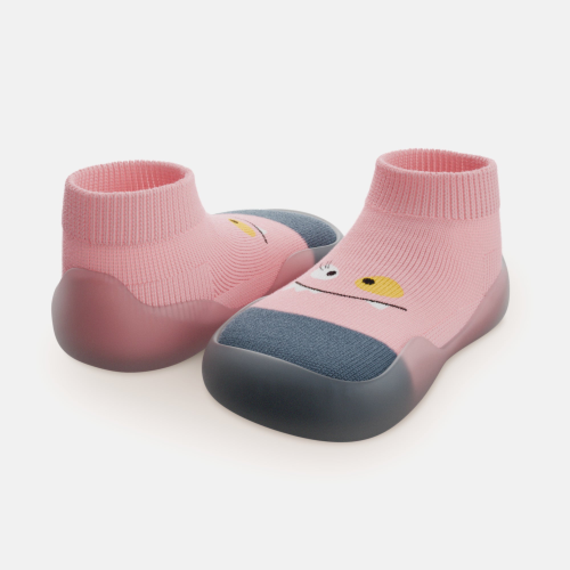 Two green and white knit slip-on shoes with gray soles.